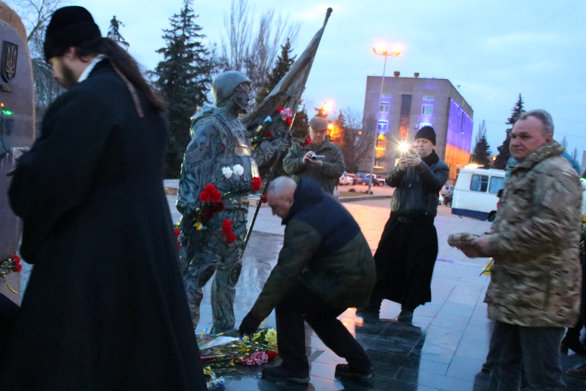 Несут цветы к мемориалу «Защитник Украины»