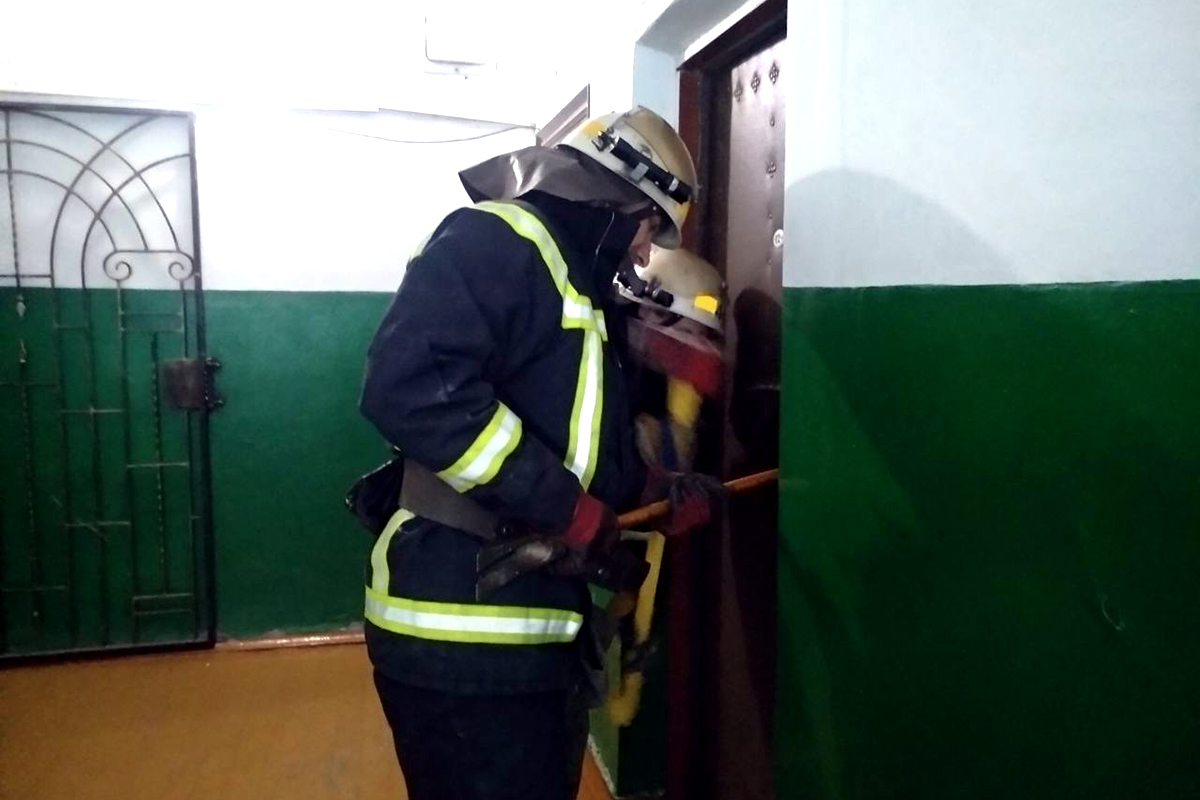 Спасатели с помощью шанцевого инструмента открыли входную дверь